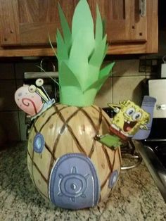 a pineapple shaped paper mache sitting on top of a counter next to a stove