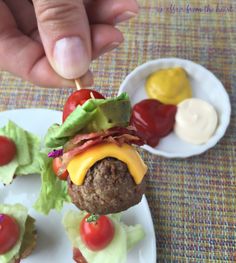 a hamburger with lettuce, tomatoes and ketchup on a skewer