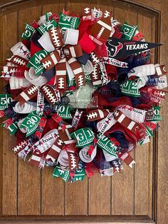 a wreath made out of footballs on the front door