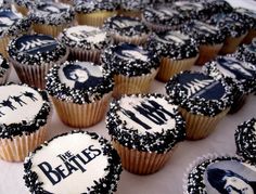 cupcakes decorated with black and white frosting depicting the band's members