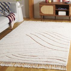 a living room with a white rug on the floor