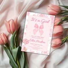 pink tulips are in front of a card with the words it's a girl on it