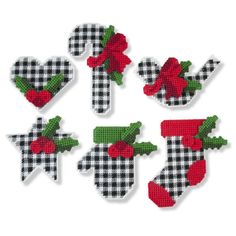 six christmas stockings with bows and holly on them, all in black and white checkered fabric