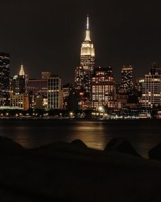 the city skyline is lit up at night