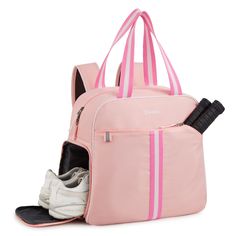 a pink handbag with two pairs of shoes in it and the bag is open