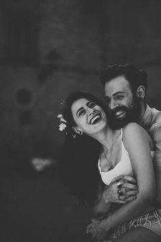 black and white photograph of a man hugging a woman