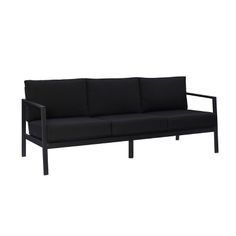 a black couch sitting on top of a white floor