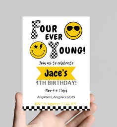 a hand holding up a birthday card that says four ever young with smiley faces on it