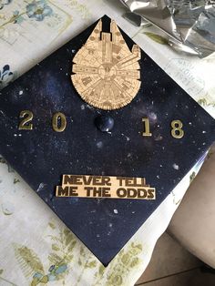 a graduation cap that says never tell me the odds