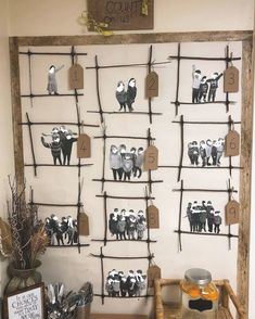 a wall hanging on the side of a building with pictures and magnets attached to it