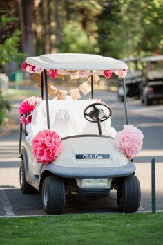 a white golf cart with pink flowers on it