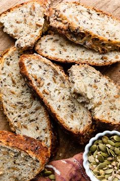 slices of bread with seeds in a bowl next to it