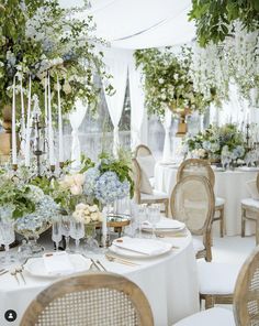 an image of a table setting with flowers and greenery on the tables at a wedding reception