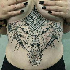 a woman with tattoos on her stomach