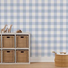 a blue and white checkered wall with toy giraffes on the top