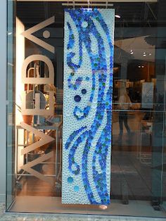 a blue and white mosaic on display in front of a store