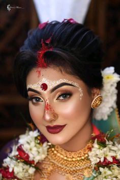 a woman with makeup and flowers in her hair