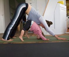 two people are doing yoga in the kitchen