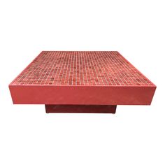 a red coffee table sitting on top of a white floor