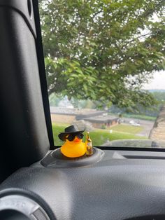 a rubber duck sitting on the dashboard of a car