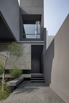 an exterior view of a modern house with stairs leading up to it