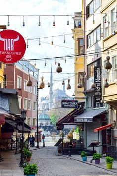 the street is lined with shops and buildings in an old european city, as well as hanging decorations