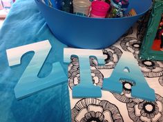 the letters are cut out and placed next to each other on a blue table cloth