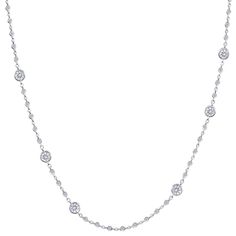 The love is in the details with this diamond by the yard necklace. Featuring an intricately detailed chain made of micro bezel diamonds that shines separating staggering larger bezel set diamonds, this 18k white gold necklace dances on your skin. So much glimmer packed into one dazzling diamond necklace that is ideal for everyday outfits! 18k White Gold 70 Round Diamonds 2.24ctw Diamonds Bezel Set Diamonds 16" Length Lobster Clasp Diamond Backdrop Necklace With Diamond Accents, Fine Jewelry Diamond Backdrop Necklace With Accents, Silver Diamond Station Necklace With Delicate Chain, Elegant Silver Station Necklace With Single Cut Diamonds, White Gold Station Necklace With Diamond Cut, White Gold Station Necklace With Delicate Diamond Chain, Luxury Diamond Station Necklace With Bezel Setting, White Gold Diamond Station Necklace With Diamond Cut, Silver Diamond Station Necklace