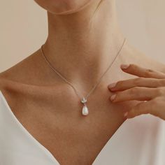 ✦ 𝐈𝐭𝐞𝐦 𝐃𝐞𝐬𝐜𝐫𝐢𝐩𝐭𝐢𝐨𝐧 Elevate your elegance with our Freshwater Pearl Diamond Necklace by Pashiminimalist. This Pearl Drop Necklace features a minimalist leaf design with sparkling crystals, perfect for a refined touch. Ideal as wedding jewelry or a thoughtful bridesmaid gift, this timeless piece adds sophistication to any occasion. ✦ Material: High Quality Solid 925 Sterling Silver ✦Finish: Sterling Silver ∙ 18K Gold ∙ Rose Gold ✦Gifting options 🎁 We can also add your personalized Modern Pearl Pendant Jewelry For Wedding, Wedding Necklace With Round Pendant And Clavicle Chain, Wedding Clavicle Chain Necklace With Round Pendant, Elegant Pearl Pendant Necklace For Wedding, Elegant Pendant Pearl Necklace For Wedding, Elegant Wedding Pearl Pendant Necklace, Elegant White Jewelry For Bridesmaid Gift, Minimalist Pearl Drop Teardrop Pendant Jewelry, Classic Sterling Silver Drop Necklace For Wedding