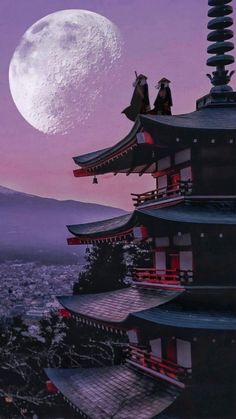 two people standing on top of a building with a full moon in the sky behind them