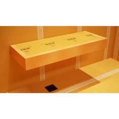 an orange shelf with two boxes on it in the middle of a room that appears to be empty