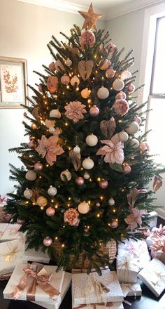 a decorated christmas tree with presents under it