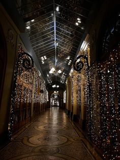 the hallway is decorated with christmas lights and chandeliers