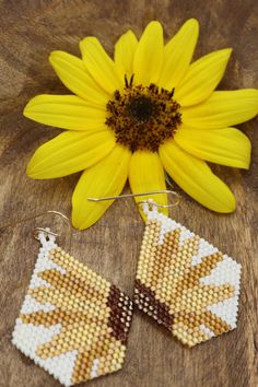 Add a little flower power to your life with our boho seed bead sunflower earrings. These beauties make the perfect statement pieces! Hand beaded dangles shades of sunshine yellow, gold, and mustard that make the perfect gift for a gardener or flower lover. 2.25 inches long 1.25 inches wide They shipped wrapped in tissue & boxed ready to gift or to treat yourself! Each pair is made to order. Shipped in 3-5 business days Summer Brown Beaded Earrings, Nickel-free Yellow Jewelry For The Beach, Adjustable Yellow Beaded Earrings With Ear Wire, Adjustable Yellow Beaded Earrings, Yellow Sunflower Dangle Earrings, Yellow Sunflower Design Dangle Earrings, Handmade Brown Beaded Summer Earrings, Yellow Beaded Earrings With Ear Wire For Festivals, Handmade Brown Beaded Earrings For Summer