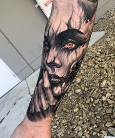 a man's arm with a black and white tattoo on it, depicting an evil woman