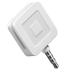 an electronic device plugged into the side of a white wall charger with a metal tip