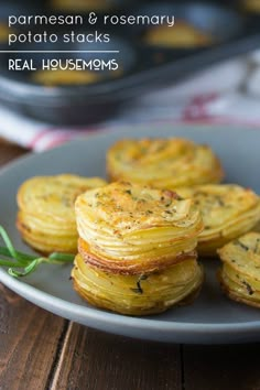 some food is sitting on a plate and ready to be eaten with the words parmesan & rosemary potato stacks real housemoms