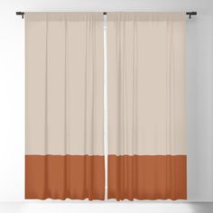 an orange and beige curtain hanging on a wall