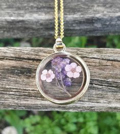 "This cute pressed flower necklace would make a great gift. It contains tiny lavender flowers and some purple ones in the back. It's adorable! The pendant measures 1 1/8\". The metal is a gold color and you can choose the length you want. This would make a great gift for mom, a birthday, an anniversary, Christmas or any other occasion. All jewelry items come in a gift box." Pressed Flowers Necklace For Mother's Day Keepsake, Flower Charm Necklace For Keepsake, Lavender Flower Jewelry With Flower Charm, Delicate Pressed Flower Necklace For Mother's Day, Keepsake Flower Necklace With Flower Charm, Lavender Flower Charm Jewelry, Lavender Flower-shaped Jewelry With Flower Charm, Purple Flower Decorated Jewelry For Gift, Pressed Flowers Necklace For Wedding And Mother's Day