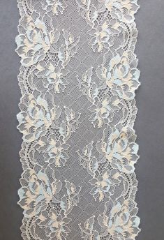 This is a top-quality stretch lace trim in light beige with a light blue and light yellow pretty floral design. Beautiful stretch lace with double flounce edges and is excellent quality with a soft handle and drape. This listing is for 1 METER = 1.09 yard width: 6.7 inch = 17 cm Ideal for sewing and craft projects. This stretch lace ideal for lingerie, bra making, clothing, accessories, doll dresses, table runner decoration, home textile, gifts, bags decoration, skirt bottoming, home decor, and Cream Lace With Lace Work For Spring, Beige Scalloped Lace For Spring, Cream Lace With Lace Trim For Spring, Blue Lace With Lace Trim For Wedding, Elegant Blue Lace With Intricate Embroidery, Luxury Romantic Lace With Lace Trim, Luxury Blue Embroidered Lace Fabric, Luxury Lace Tulle Fabric With Lace Trim, Evening Gala