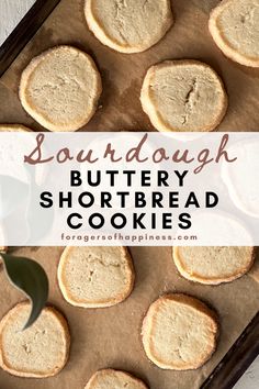 some shortbread cookies are sitting on a baking sheet with the words sourdough buttery shortbread cookies