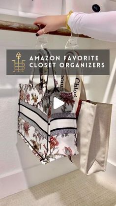 an amazon favorite closet organizer is hanging on the wall in front of a woman's hand