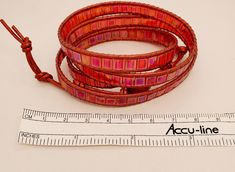 Red, red, red iridescent Tila tile beads and 1.5mm metallic red leather cord make up this multi-wrap bracelet. Length can be adjusted. It's easy to cut off excess leather and knots. Closure is beautiful domed and faceted flower-shaped red button. Knotted leather loops. Designed and created by TLP of Takeen Arts. Item B485. Red Adjustable Bohemian Wrap Bracelet, Handmade Adjustable Red Wrap Bracelet, Adjustable Red Handmade Wrap Bracelet, Adjustable Red Wire-wrapped Jewelry, Red Wrap Bracelet With Round Beads, Adjustable Wire Wrapped Red Jewelry, Adjustable Red Wire Wrapped Jewelry, Red Hand Wrapped Wrap Bracelet With Round Beads, Red Hand Wrapped Wrap Bracelet As Gift