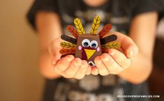 a person holding a paper turkey in their hands