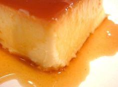 a piece of cheesecake covered in caramel sauce