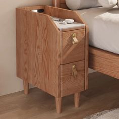 a bed with a wooden night stand next to it