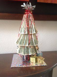 a christmas tree made out of money on top of a table