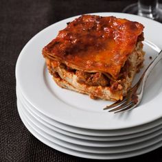 a plate with lasagna and fork on it