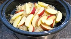 there are many pieces of fruit in the bowl on the counter top, including apples