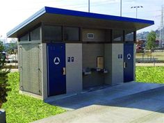 an outdoor restroom with blue and gray doors